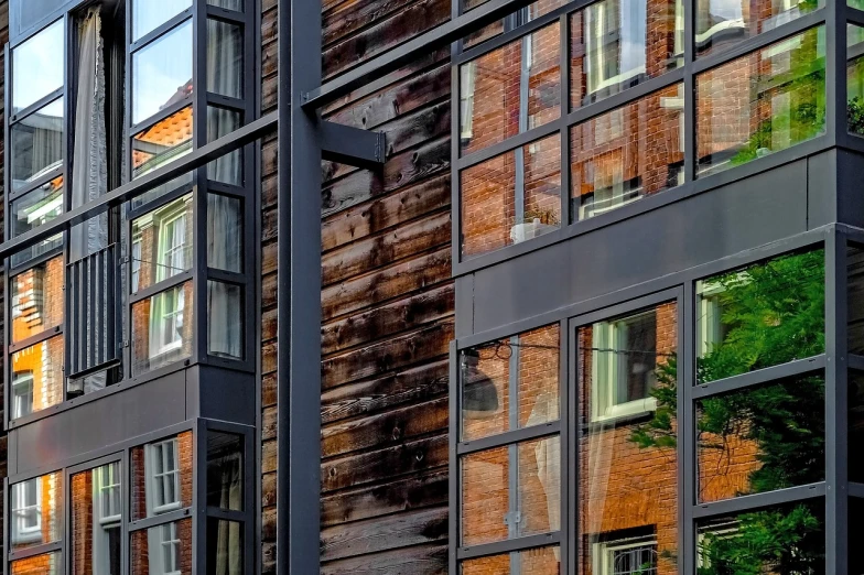 a clock that is on the side of a building, a photo, inspired by John Haberle, modernism, window reflections, wooden house, hdr detail, hannover