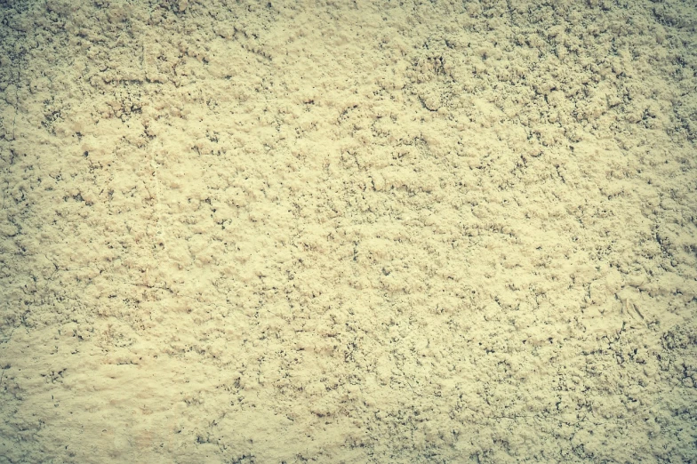 a close up of a wall with sand on it, a stock photo, shutterstock, art deco, vintage saturation, bangalore, powder, vintage sci-fi soft grainy