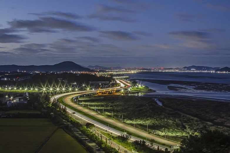 an aerial view of a highway at night, a portrait, by Jang Seung-eop, flickr, seaside, city twilight landscape, 2 4 mp, korean countryside
