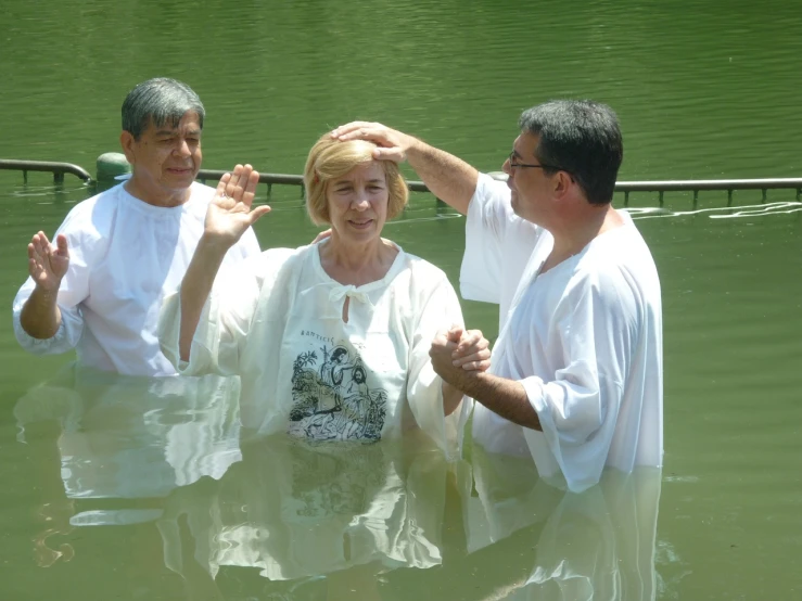 a group of people standing in a body of water, sacrament, in sao paulo, joyce ballantyne, couple