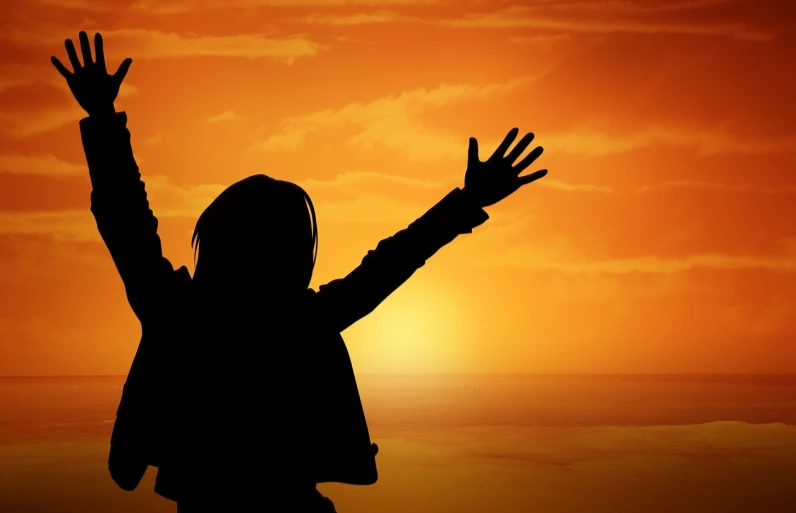 a silhouette of a person raising their hands in the air, romanticism, istockphoto, hug, happy girl, victory