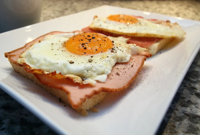 a close up of a plate of food on a table, by Matteo Pérez, flickr, eggs, ham, sandwich, cute:2