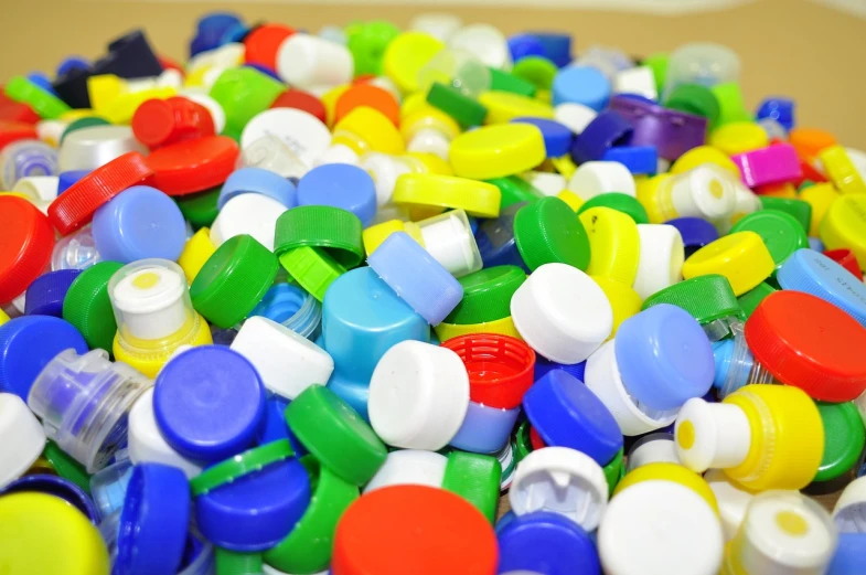 a pile of plastic bottle caps sitting on top of a table, flickr, full of colour 8-w 1024, bottom shot, product introduction photo, dubai