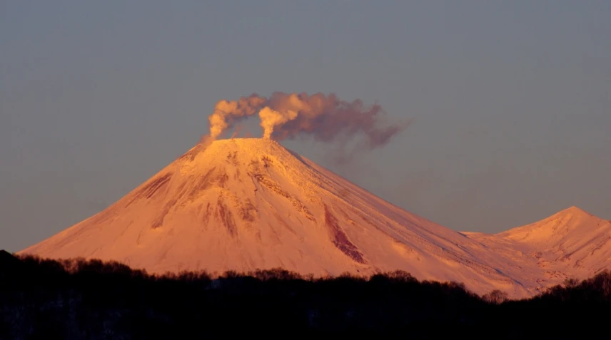 a mountain with a plume of smoke coming out of it, by Andrei Kolkoutine, flickr, mingei, at snowy fuji mountain sunrise, nice afternoon lighting, molten, pareidolia