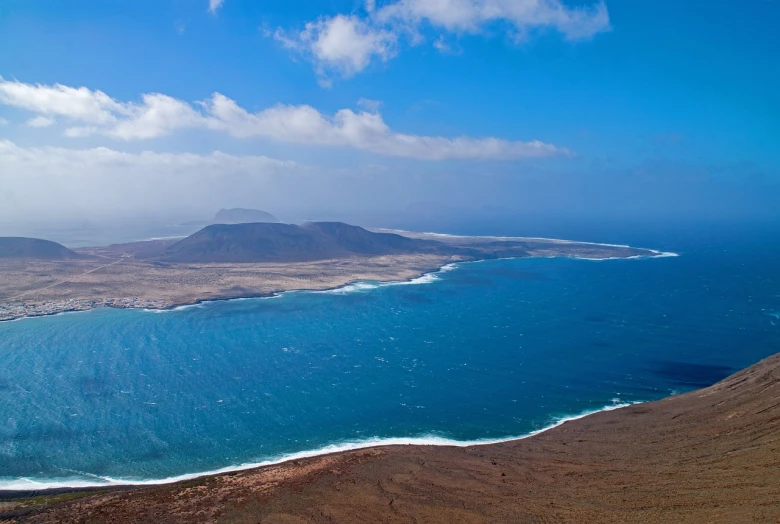 a large body of water with mountains in the background, a photo, by Juan O'Gorman, hurufiyya, view from above on seascape, mesa, islandpunk, iso 1 0 0 wide view