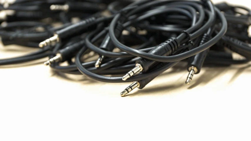 a pile of black wires sitting on top of a table, antipodeans, earbuds, reduce duplication interference, lowres, inputs