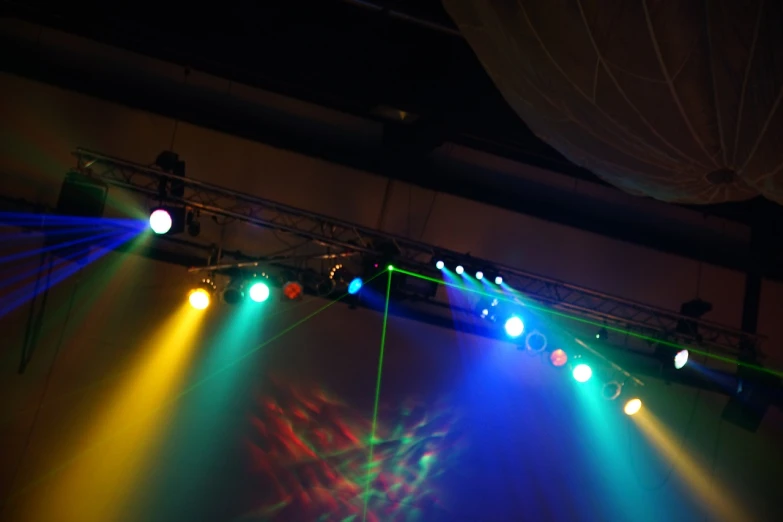 a group of lights that are on a stage, a picture, by Jan Rustem, flickr, bottom - view, disco, spotlight at a 90 degree angle, standing under a beam of light