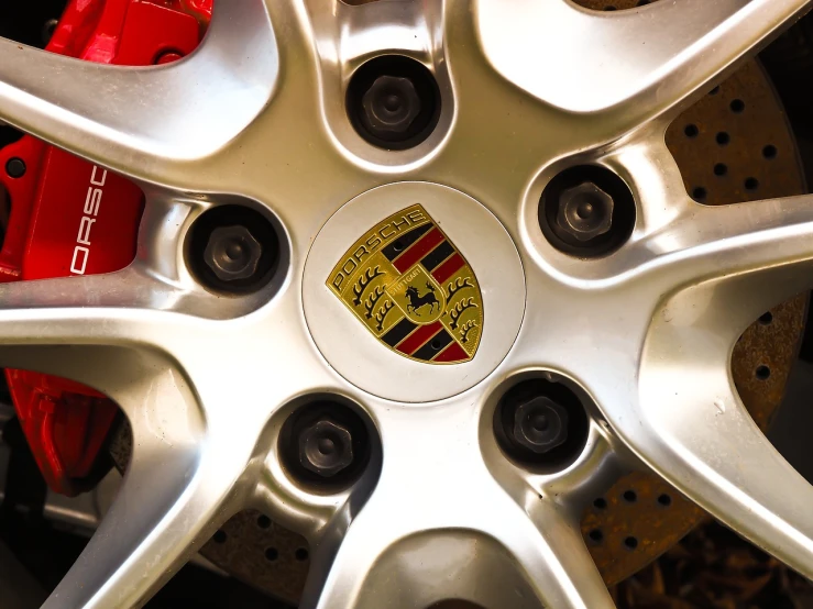 a close up of a wheel on a car, a stock photo, by Paul Emmert, renaissance, porsche, chicago, panel, discovered photo