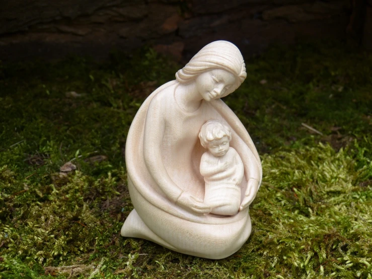 a statue of a woman holding a child, a statue, inspired by Mary Syme Boyd, figuration libre, carved ivory, in serene forest setting, epiphany, wooden decoration