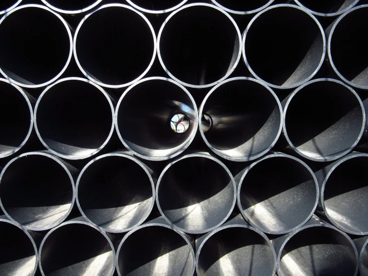 a bunch of metal pipes stacked on top of each other, unsplash, plasticien, black round hole, centre image, crisp smooth lines, whole-length