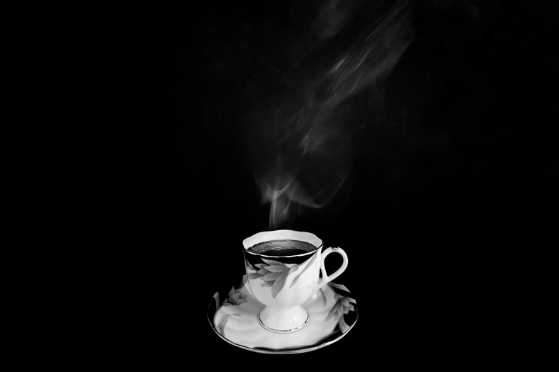 a cup of coffee sitting on top of a saucer, a black and white photo, inspired by Carrie Mae Weems, dramatic smoke, high res photo