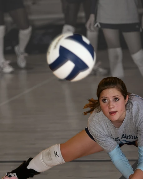 a female volleyball player dives to hit the ball, a portrait, by Paul Davis, flickr, kneeling, student, crisp face, laying down