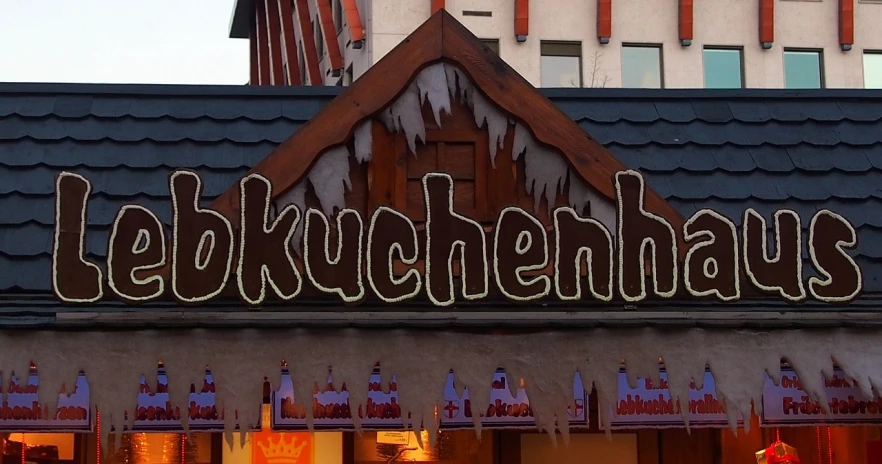 a sign that is on the side of a building, inspired by Jan Kupecký, incoherents, octoberfest, kunoichi, amusement park buildings, backlit