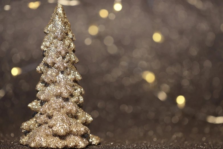 a gold christmas tree sitting on top of a table, a picture, pexels, folk art, glitter background, silver, profile picture, background image