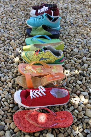 a row of shoes sitting on top of a pile of rocks, inspired by Jan Rustem, flickr, cheerful colours, overview, unrea 5, various items