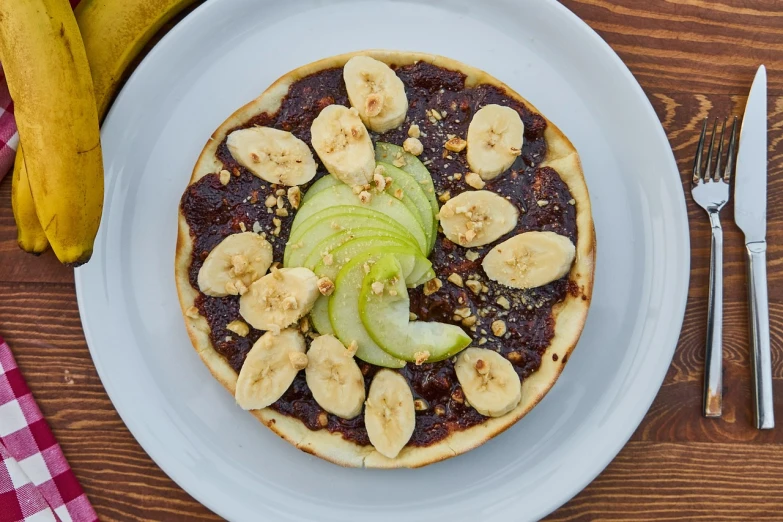 a white plate topped with a pizza covered in fruit, inspired by Richmond Barthé, banana, 3 4 5 3 1, healthy, caramel