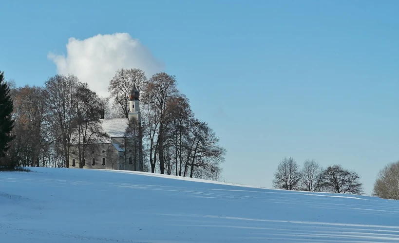 a church sitting on top of a snow covered hill, a photo, by Bernd Fasching, flickr, baroque, meadows, with trees, white clouds, biedermeier