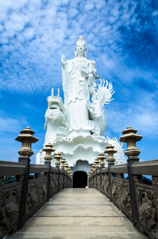 a large white statue sitting on top of a bridge, a statue, inspired by Pu Hua, highly detail wide angle photo, queen of heaven, walking towards the camera, inside view