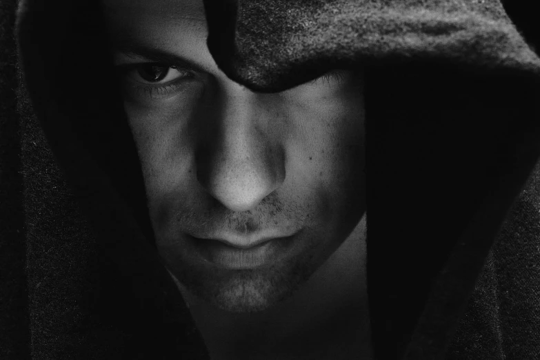 a black and white photo of a man in a hoodedie, inspired by Peter Basch, unsplash, digital art, vin diesel, seductive eyes, black hood, closeup portrait of an mage