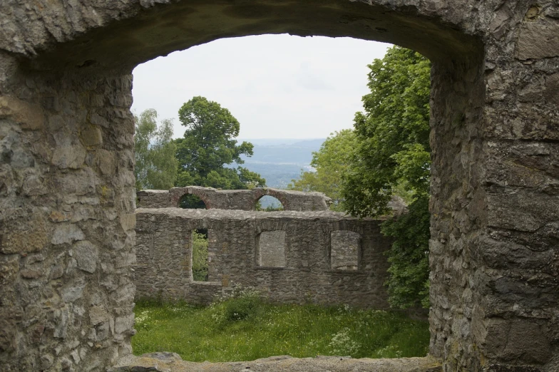 a view of a stone building through a window, castle ruins, mundy, information, overview