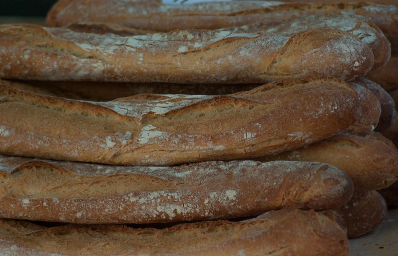 a bunch of baguettes stacked on top of each other, a picture, inspired by Normand Baker, pexels, figuration libre, highly detailed close up shot, crackles, normandy, in a row
