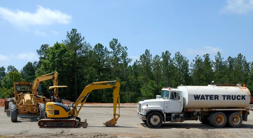 a couple of trucks that are sitting in the dirt, flickr, alabama, ground breaking, some of the blacktop is showing, july 2 0 1 1