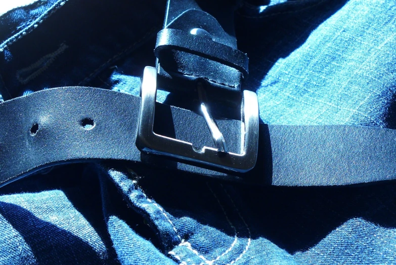 a close up of a belt on a person's jeans, a picture, figuration libre, iphone capture, nice afternoon lighting, hdr photo, abstract black leather