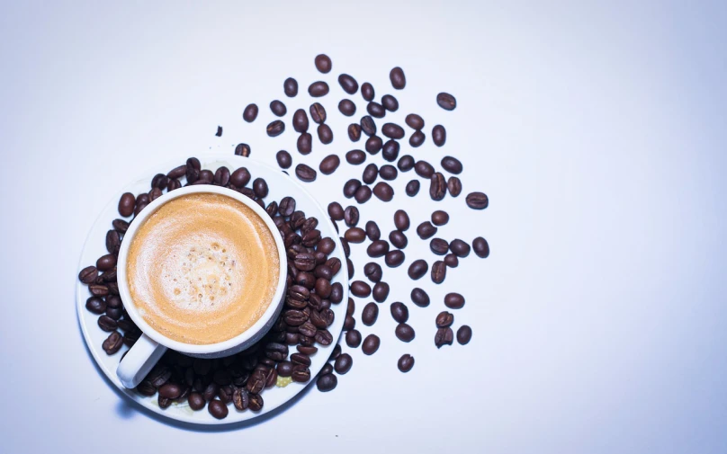 a cup of coffee surrounded by coffee beans, minimalism, white background!!!!!!!!!!, 4 k product photo