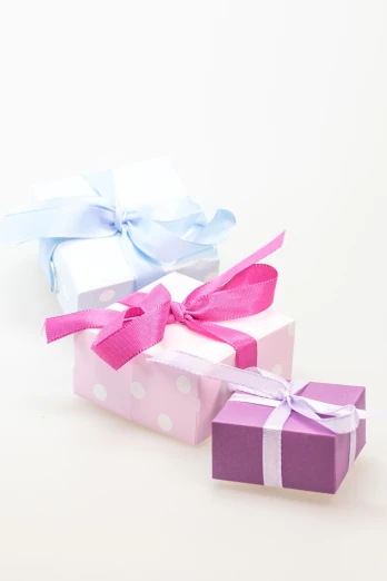 a couple of gift boxes sitting next to each other, by Rhea Carmi, pexels, figuration libre, white and purple, white and pink, threes, background image