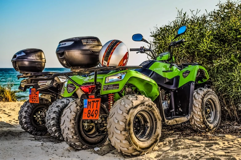 a green atv sitting on top of a sandy beach, a picture, by Frederik Vermehren, shutterstock, hdr photo, ultra hd wallpaper, heavily equipped, outdoor photo