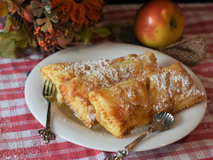 a close up of a plate of food on a table, by Alice Mason, pixabay, renaissance, apple pie, powdered sugar, square, autum