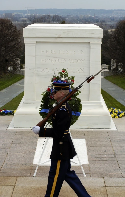 a man in a military uniform holding a rifle, by Ken Elias, flickr, symbolism, inside a tomb, inauguration, view from the side”, wikimedia commons