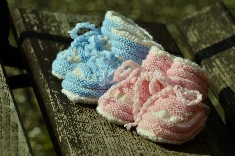 a pair of baby shoes sitting on top of a wooden bench, by Alice Mason, figuration libre, pink and blue colour, 8 8 8 8, beginner, cotton