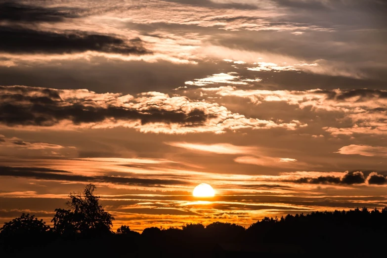 the sun is setting behind the clouds in the sky, a picture, by Karl Hagedorn, shutterstock, summer night, very detailed picture, photo taken with sony a7r, late summer evening