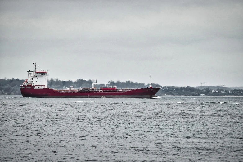 a large boat traveling across a large body of water, a photo, by Mathias Kollros, flickr, vibrant but dreary red, highfleet, petros, around the city