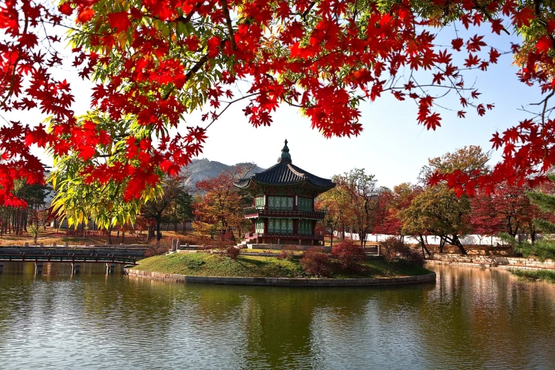 a pagoda in the middle of a lake surrounded by red leaves, inspired by Byeon Sang-byeok, amazing wallpaper, parks and gardens, beatiful house, on a sunny day