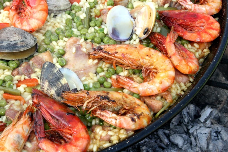 a pan filled with lots of different types of food, a portrait, by Matteo Pérez, pixabay, hurufiyya, gills and scales, costa blanca, outside, celebrating