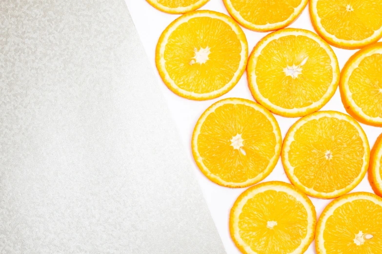 a bunch of orange slices sitting on top of a table, inspired by Christo, trending on unsplash, silver and yellow color scheme, 🦩🪐🐞👩🏻🦳, half image, detailed product photo