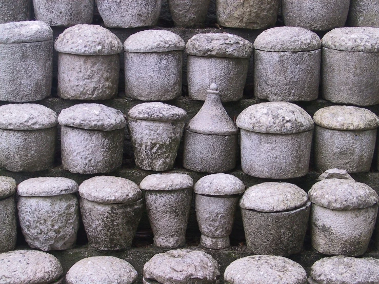 a pile of cement pots sitting next to each other, by Yasushi Sugiyama, flickr, mushroom cap, castle wall, kumamoto, grain”