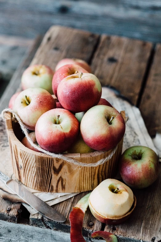 a basket of apples sitting on top of a wooden table, pexels, instagram photo, wooden bowl, round cheeks, rustic