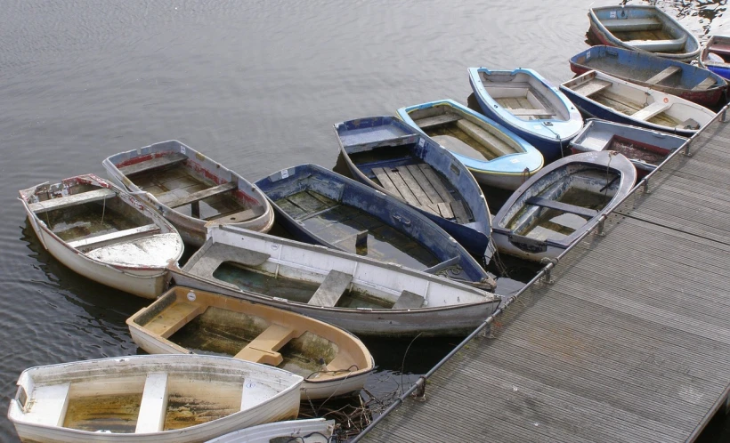 a group of small boats sitting on top of a wooden dock, by John Murdoch, flickr, on flickr in 2007, boston, [ [ hyperrealistic ] ], brockholes