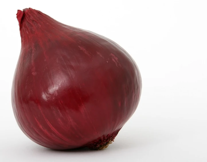 a close up of a red onion on a white surface, by Unkoku Togan, hurufiyya, istockphoto, view from the side, eero aarnio, orthodox