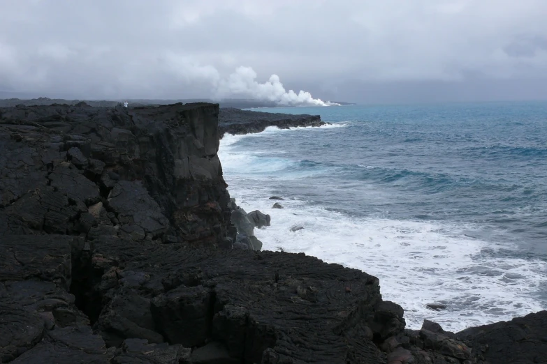 a man standing on top of a cliff next to the ocean, by Dennis Ashbaugh, flickr, mingei, lava and smoke, view from the side”, flora-lush-crater, seen from the side