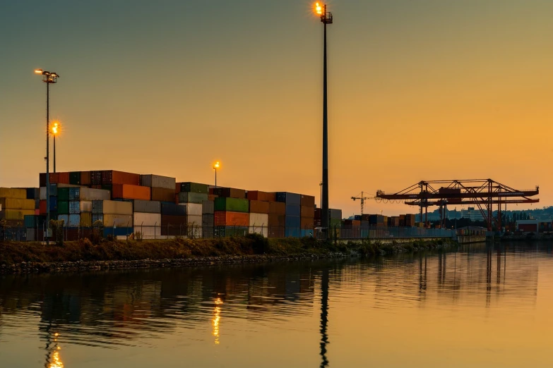a large container ship sitting on top of a body of water, a portrait, by Thomas Häfner, shutterstock, peaceful evening harbor, portrait of tall, trading depots, 2 4 mm iso 8 0 0 color