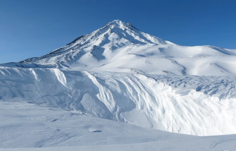 a man riding skis down a snow covered slope, a picture, by Andrei Kolkoutine, hurufiyya, an ice volcano, the photo shows a large, detailed white, 8 k vertical wallpaper