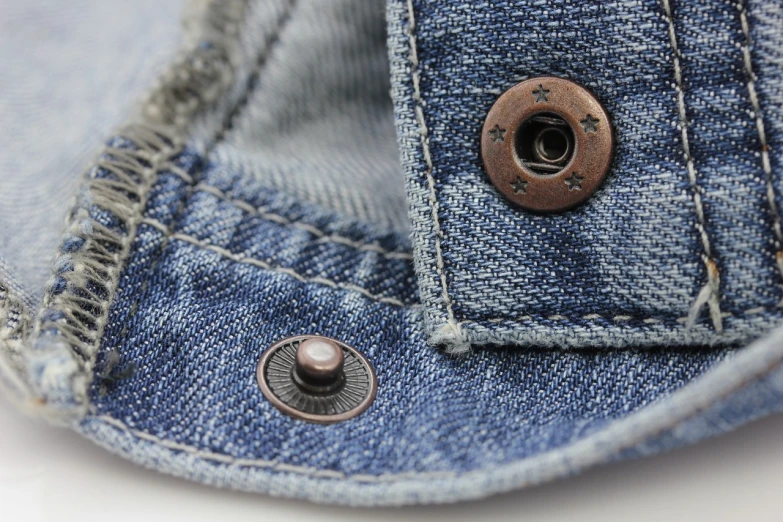 a close up of a button on a pair of jeans, by Steve Argyle, neo-dada, highly detailed product photo, small hat, bellybutton, screw