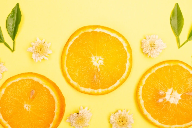 orange slices with leaves and flowers on a yellow background, by Anna Haifisch, trending on unsplash, minimalism, background image, 🐿🍸🍋, wallpaper - 1 0 2 4, orange minerals