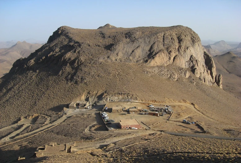 an aerial view of a small town in the desert, a portrait, by Dietmar Damerau, flickr, les nabis, big sharp rock, hut, egyptian setting, military base