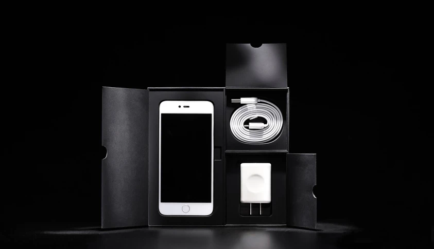 a white cell phone sitting inside of a black box, professional product shot, product introduction photo, items and gadget, high - end