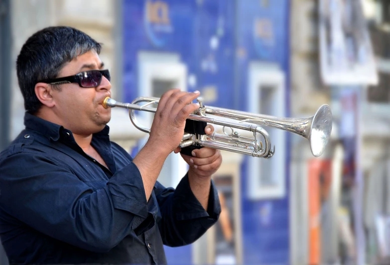 a man playing a trumpet on a city street, by Jan Rustem, pixabay, ranjit ghosh, performing on stage, shiny silver, on a bright day